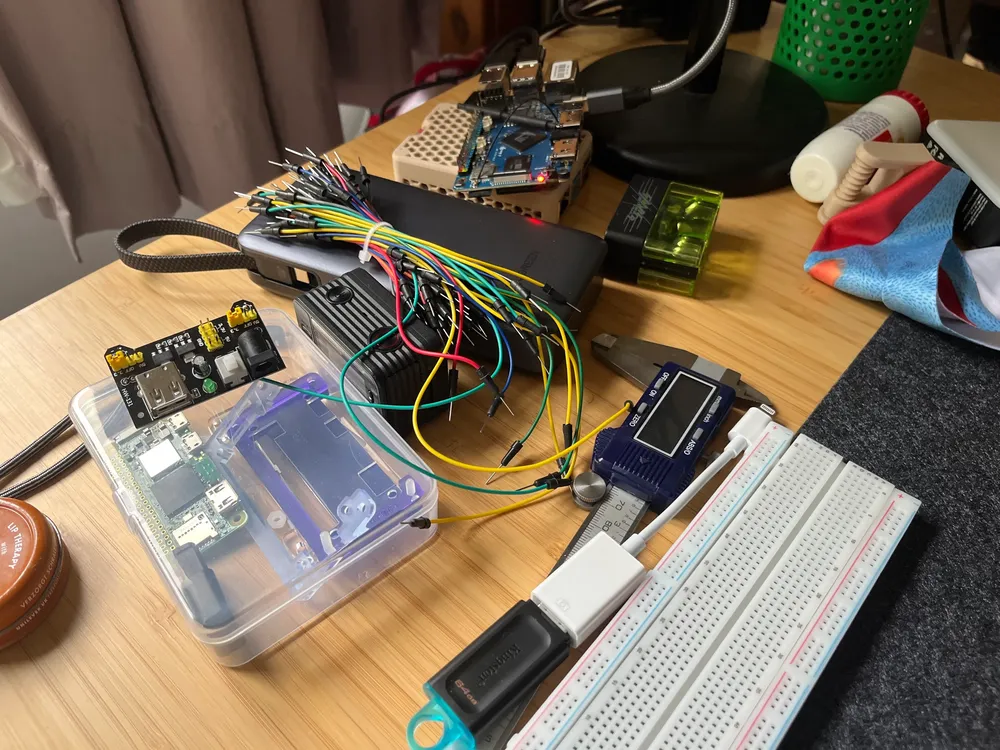 a few raspberry pis, an orange pi, a breadboard, a power bank and some cables
